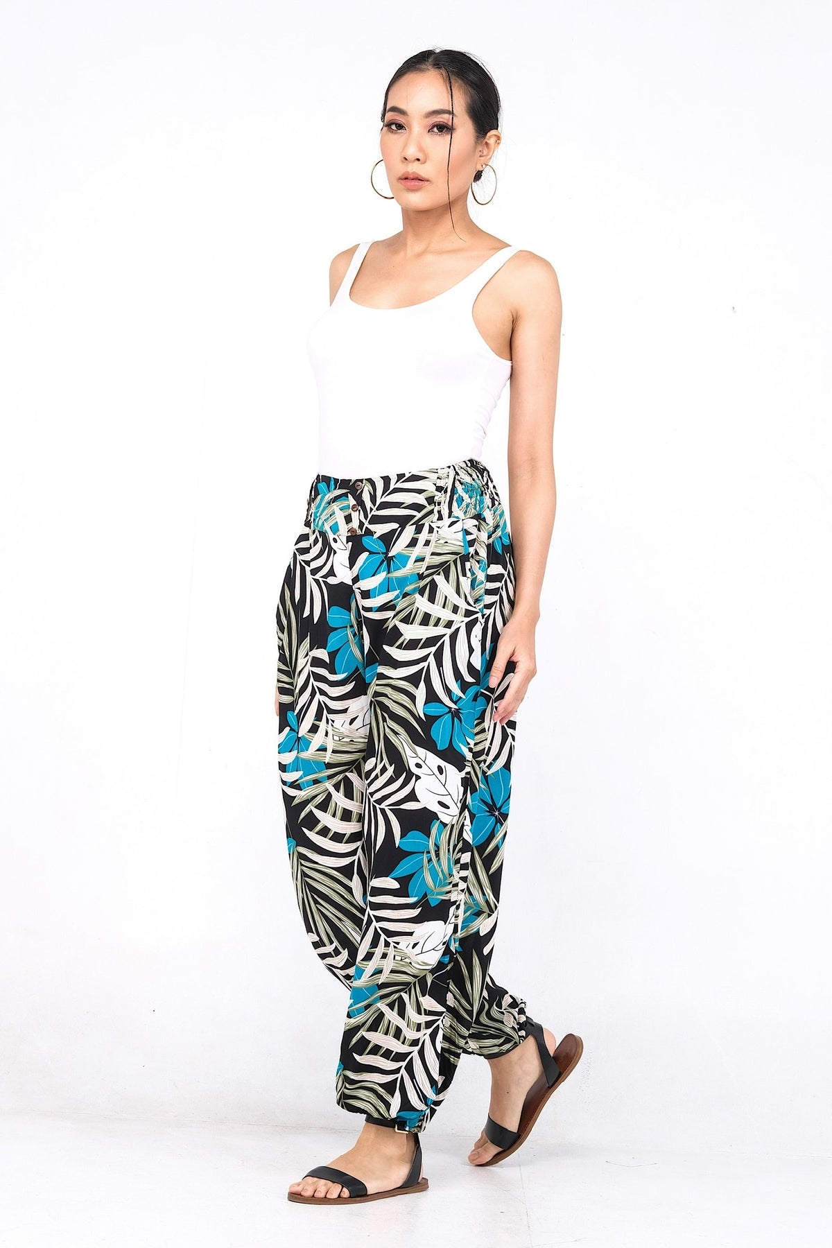 Pantalon en viscose légère, doté d'une ceinture élastique ornée de trois boutons. Idéal pour un confort estival avec ses chevilles élastiques.